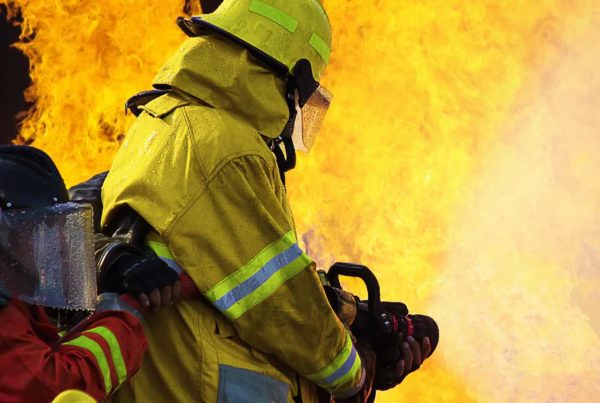 Image of a firefighter extinguishing a fire