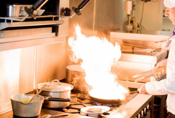 Image of a chef cooking in a commercial kitchen