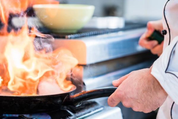 Image of a chef cooking in a commercial kitchen