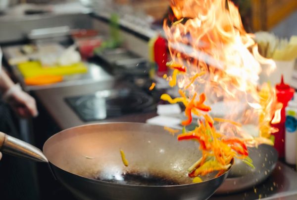 A chef cooking in a commercial kitchen