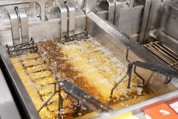 Deep fryer with boiling oil in restaurant kitchen