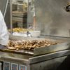 Chicken Cooking on an industrial Kitchen Griddle