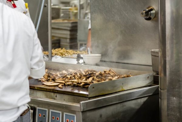 Chicken Cooking on an industrial Kitchen Griddle